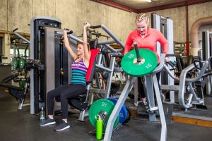 Fitness Centre women using upper body machine weights